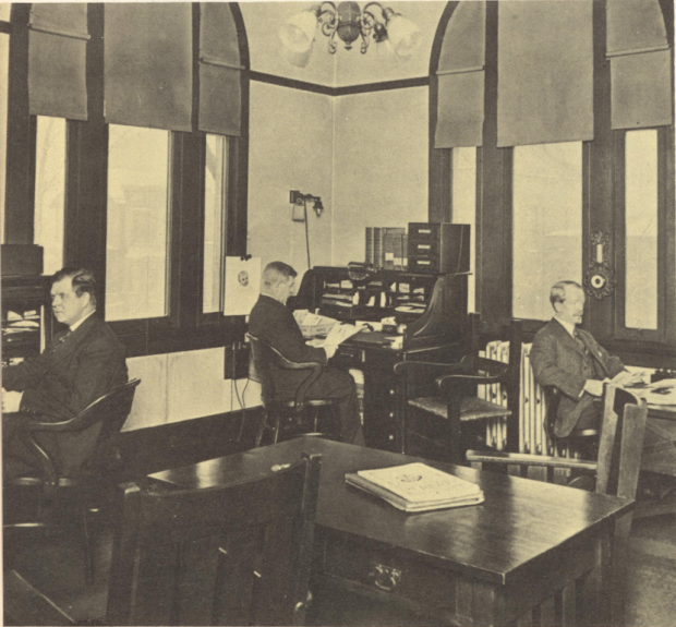 Sepia photograph of three men in a room.