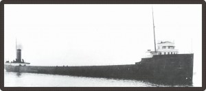 Black and white photo of a very long steamboat.