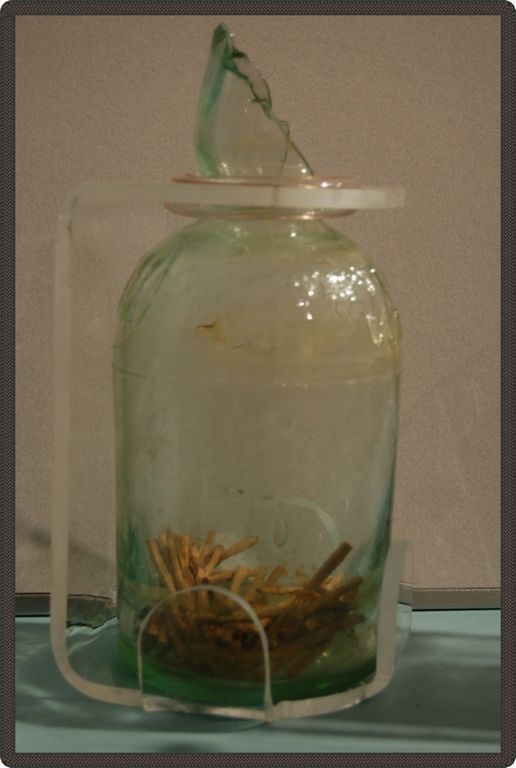 Glass container containing many wooden matches.