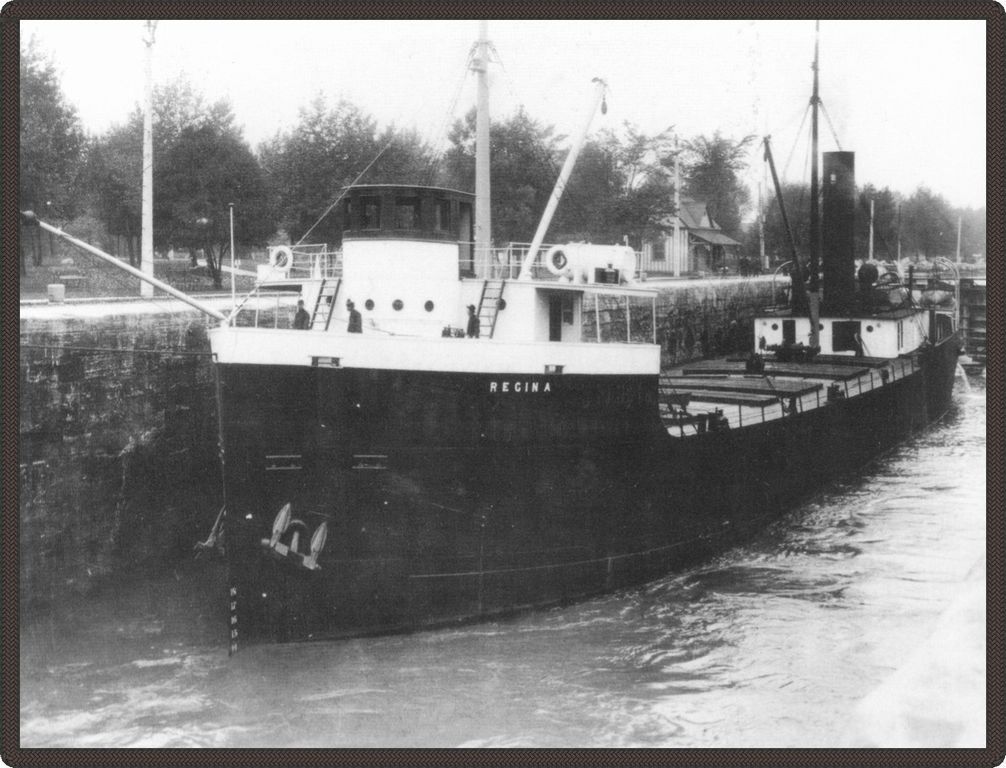 Black and white photo of a docked boat.