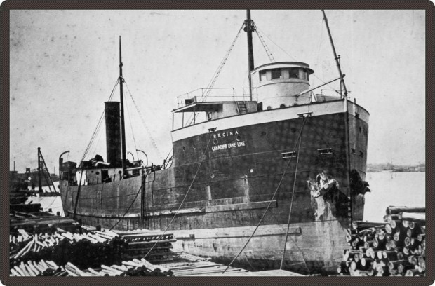 Black and white photo of a docked ship.