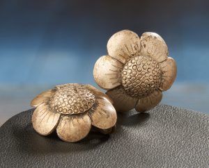 Silver earrings in the shape of small six petalled flowers.