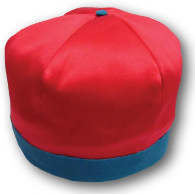 Image of a rowing cap worn by the members of the Paris Crew. This replica is made of a satin-like material and pink in colour with blue trim and accents.