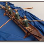 Wooden sculpture of a four-man rowing crew in their rowing scull