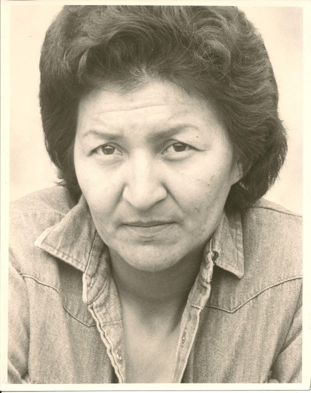 A black and white portrait of a young Dorothy McDonald with short black hair looking forward.