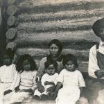 An Aboriginal Family in Front of a Log Cabin