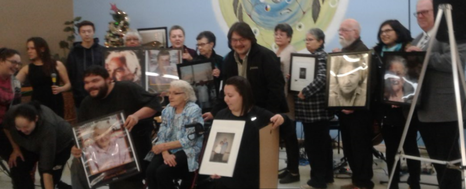 Coloured photo of multiple people holding photos .