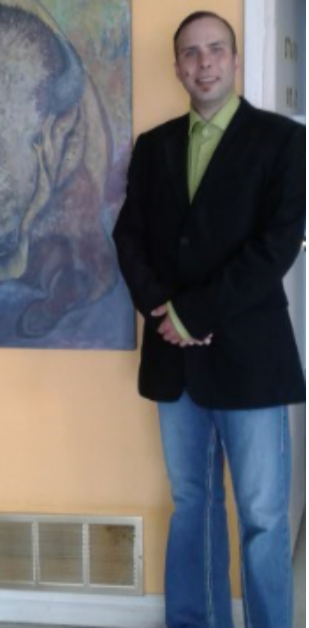 Jonathan Meilleur standing beside a painting of a buffalo.