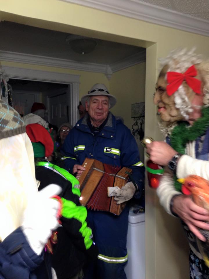 A man plays accordion for the mummers