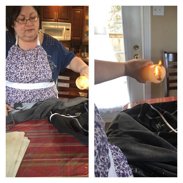 Maureen Whyte dropping the wax from a blessed candle onto clothing on Candlemas Day