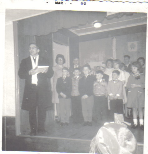 Children on stage as the priest introduces the Paddy's Day concert