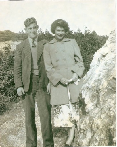 a young couple walks down a rocky path