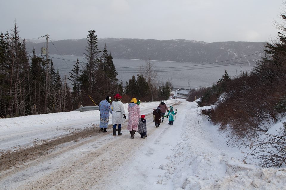 Mummers walking on snow covered road in Parker's Cove