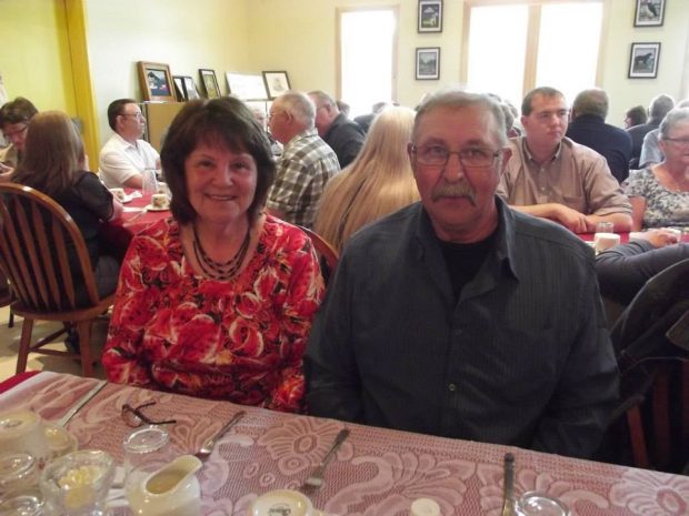 A woman and a man sit together at a table at a special community dinner