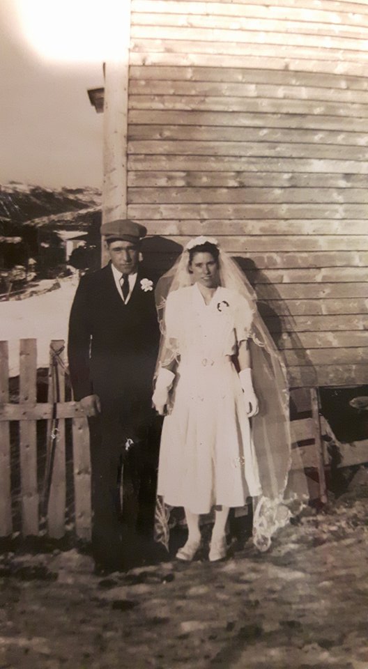 Bride and groom walk along a wooden walkway