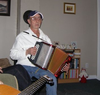 A man plays an accordion at a house party