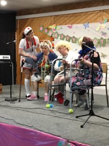 A group of women on stage doing a skit