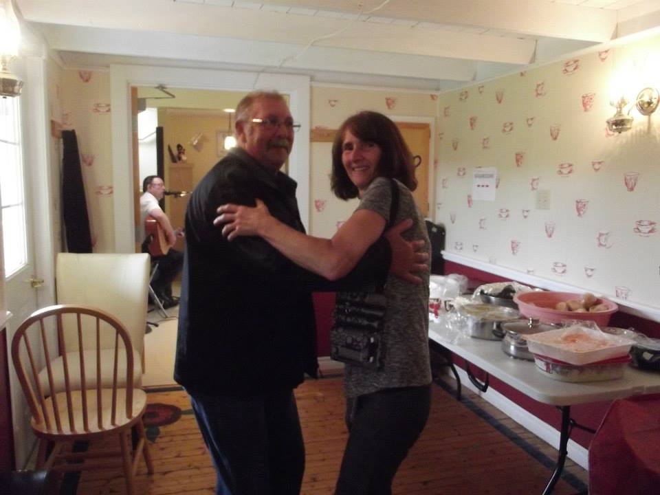 A man and a woman waltz in a restaurant