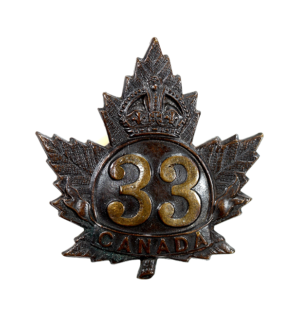 A badge in the shape of a maple leaf with a crown, number 33 and Canada.