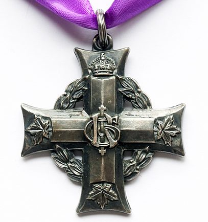 A silver Greek cross suspended to a purple ribbon through a small ring. A laurel wreath under the arms of the cross. A cypher is at the intersection of the cross' arms. A crown at the end of the top arm, 3 maple leaves at the end of the other arms.