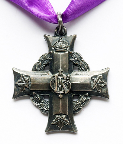 A silver Greek cross suspended to a purple ribbon through a small ring. A laurel wreath under the arms of the cross. A cypher is at the intersection of the cross' arms. A crown at the end of the top arm, 3 maple leaves at the end of the other arms.