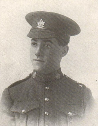 Portrait of a soldier wearing a peak hat. Chest pockets, buttons and collar dogs can be seen.