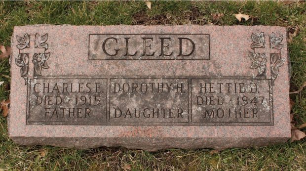 A stone grave with engraved inscription and ornaments.