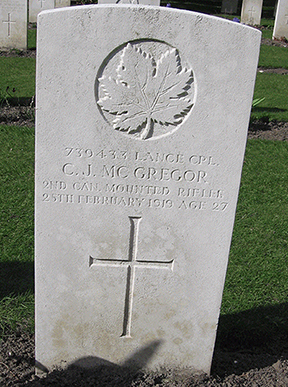 A grave stone with a cross and maple leaf.