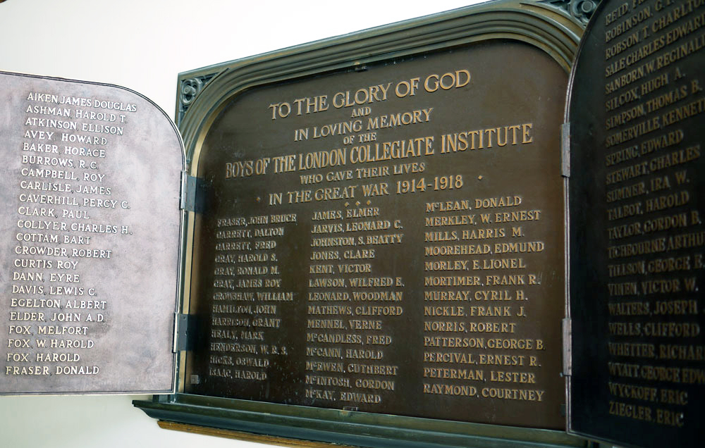 A rectangular plaque made of brass with symmetric ornaments on the top right and left. Two smaller plaques are attcahed with hinges and they open like a window to reveal names of soldiers.