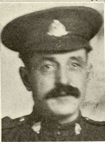 Portrait of a soldier wearing peak hat. He has a moustache.