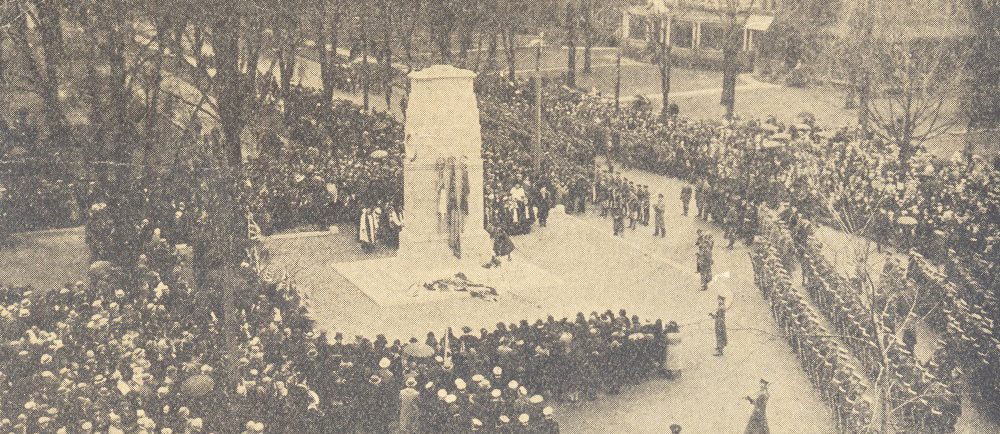 A monument surrounded by military and general public.