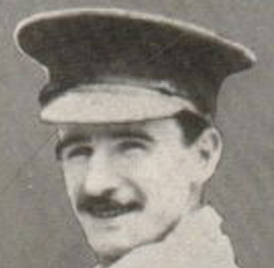 Portrait of a soldier wearing a peak hat. He has a moustache.