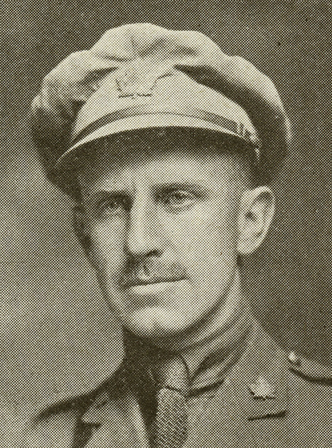 Portrait of a soldier wearing peak hat. He has a moustache.