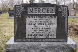 Une pierre tombale ornée et gravée d’inscriptions. Le mot « MERCER » est gravé au sommet.