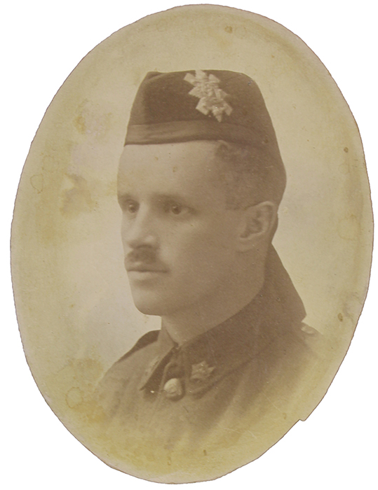 Portrait of a soldier with a moustache. he wears a wedge hat with badge and ribbons at the back (Highlander)