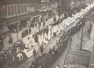 Black and white photograph showing a parade of nurses.