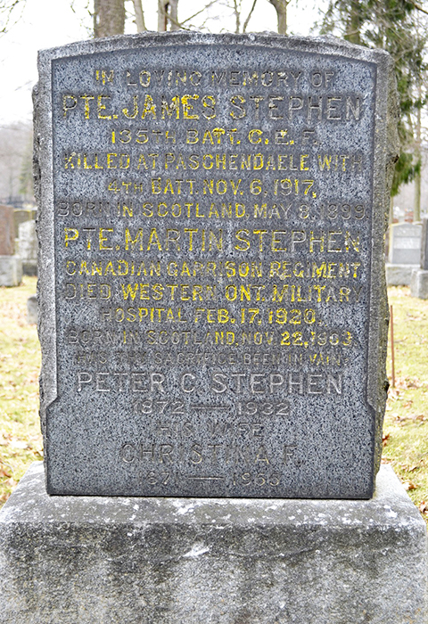 A grave stone with writings carved in.