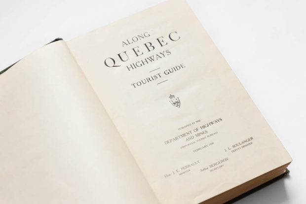 Colour photograph of the title page of the tourist guide Along the Quebec Highways. It is written: Along Quebec Highways Tourist Guide. Published by the Department of Highways and Mines (Provincial Tourism Bureau), February 1930. Names of officials: Minister J. E. Perrault, Deputy Minister J. L. Boulanger and Secretary Arthur Bergeron.