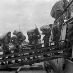 Canadian soldiers board a ship