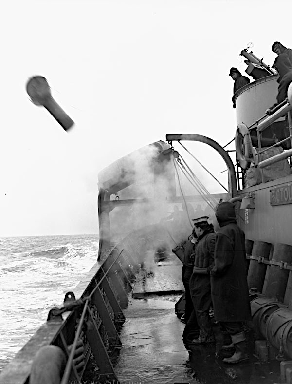 Sailors on warship launching a depth charge