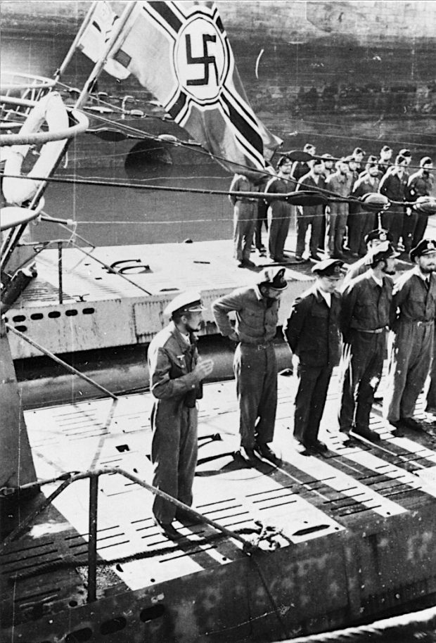 Two submarines with crewmen on their decks