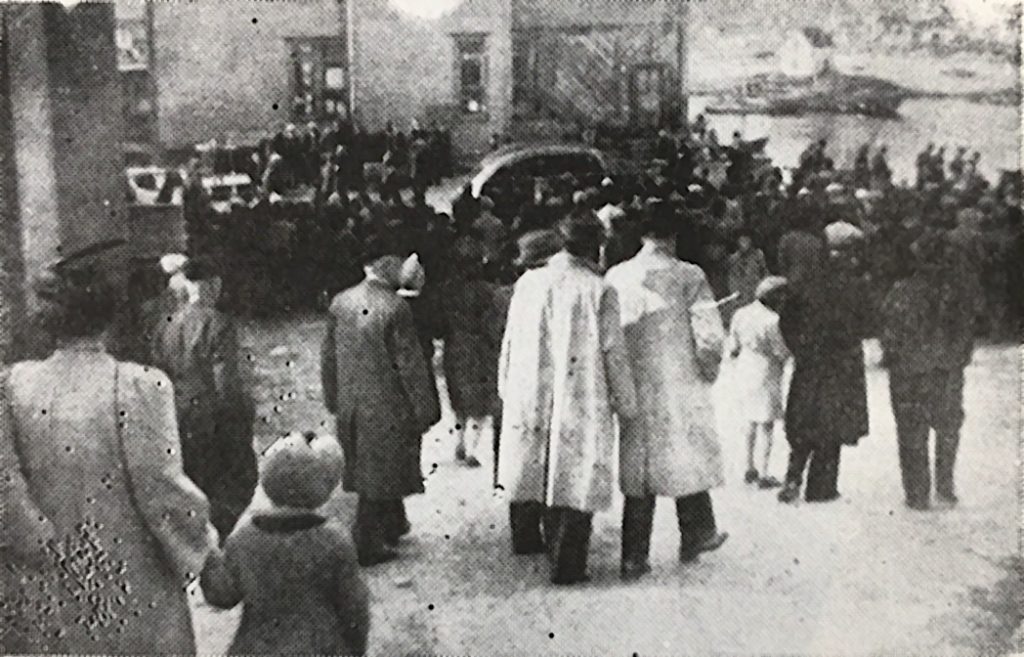 Funeral procession of men, women and children