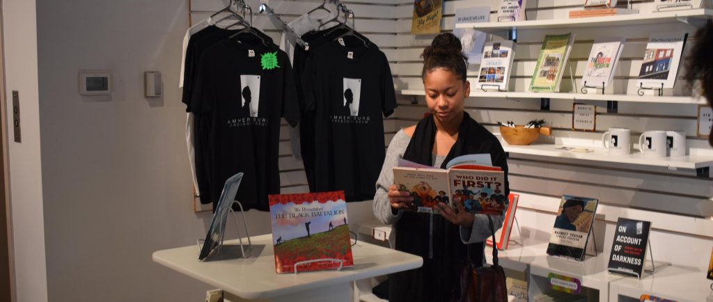 Gabriela engaged in reading a children's book during the museum visit.