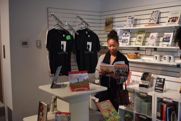 Gabriela engaged in reading a children's book during the museum visit.
