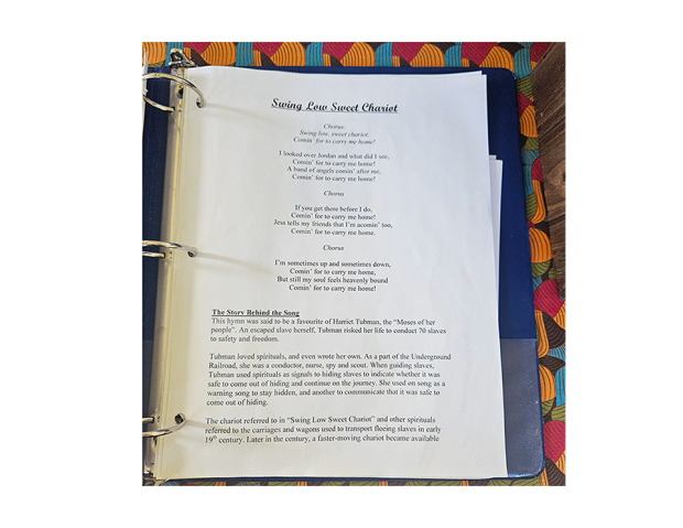 Page from a songbook showing lyrics to 'Swing Low Sweet Chariot' and historical context about Harriet Tubman and the Underground Railroad.
