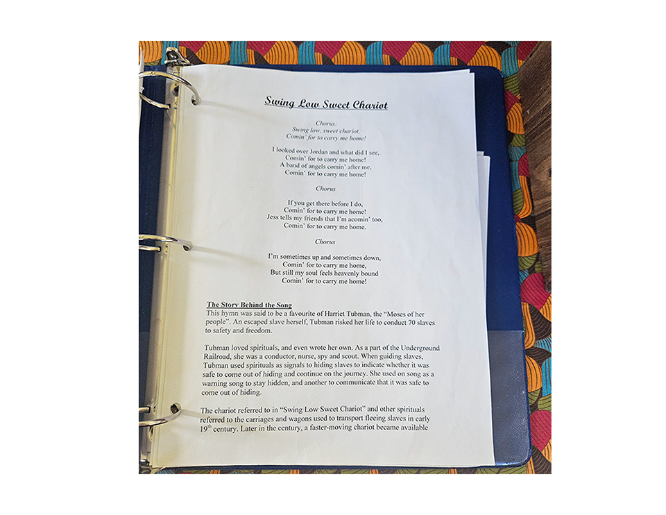 Page from a songbook showing lyrics to 'Swing Low Sweet Chariot' and historical context about Harriet Tubman and the Underground Railroad.