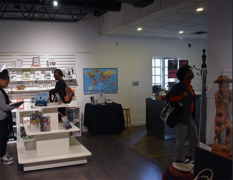 Interior of the Amherstburg Freedom Museum, featuring researchers browsing curated displays of literature, educational materials, and local artwork.