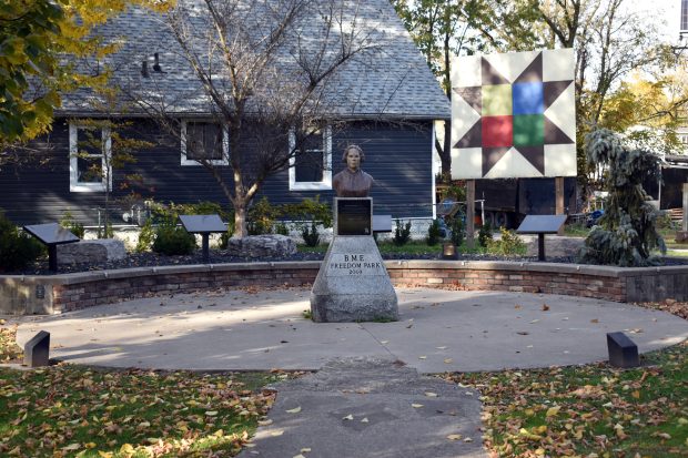 A bronze bust of Mary Ann Shadd Cary is mounted on a stone pedestal engraved with “B.M.E. Freedom Park 2009.” A plaque is affixed to the front, honouring her legacy as a teacher, publisher, and civil rights advocate.