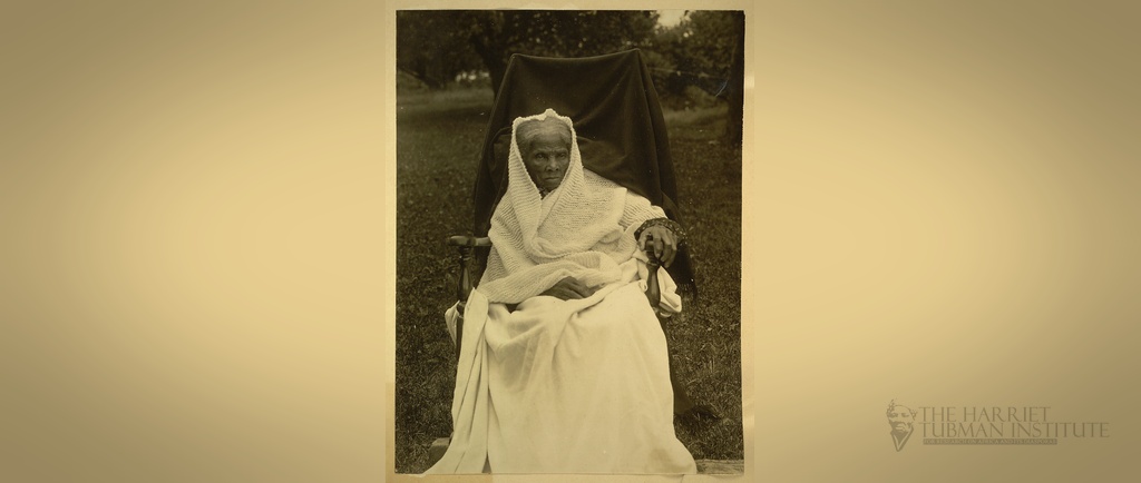 A historic black-and-white portrait of Harriet Tubman, centered horizontally with softened edges and a project logo placed in the bottom-right corner.