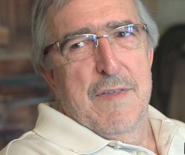 Close-up of Ernest Labelle with grey hair, a grey moustache and glasses.